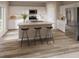 Bright eat-in kitchen showcasing an island with bar stool seating, stainless steel appliances, and light wood flooring at 3787 King Hill Dr, Haines City, FL 33844