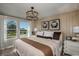 Beautiful main bedroom features a large window with views, decorative lighting, and stylish wall decor at 3795 King Hill Dr, Haines City, FL 33844