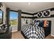 A themed bedroom has a large window, guitars on the wall, records, and a record player on the dresser at 3799 King Hill Dr, Haines City, FL 33844
