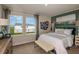 Bright bedroom with a large window, white bedding, an accent wall, and decorative table lamps at 3799 King Hill Dr, Haines City, FL 33844