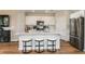 Stylish kitchen featuring an island with seating, stainless steel appliances, and ample cabinet space at 3799 King Hill Dr, Haines City, FL 33844