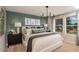 Serene main bedroom featuring a plush bed, stylish decor, and a bright window at 3799 King Hill Dr, Haines City, FL 33844