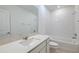 Bright bathroom with a vanity, framed mirror, and white subway tile in the shower at 9084 Wildlight Trl, Wildwood, FL 34785