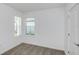 Neutral bedroom with a window providing natural light, plush carpet flooring, and white walls at 9084 Wildlight Trl, Wildwood, FL 34785