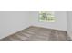 Comfortable carpeted bedroom, illuminated by a single window, offers a peaceful retreat for rest and relaxation at 9084 Wildlight Trl, Wildwood, FL 34785