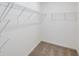 Walk-in closet with multiple shelves, providing ample storage and organization solutions for your wardrobe at 9084 Wildlight Trl, Wildwood, FL 34785