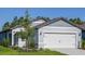Charming single-Gathering home showcases a well-manicured lawn and an attached two-car garage, providing comfortable living at 9084 Wildlight Trl, Wildwood, FL 34785