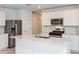 Modern kitchen features stainless steel appliances, ample counter space, and sleek white cabinetry for a stylish cooking experience at 9084 Wildlight Trl, Wildwood, FL 34785