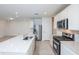 Bright kitchen boasts a large center island, stainless steel appliances, and an adjacent living area at 9084 Wildlight Trl, Wildwood, FL 34785