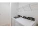 Bright laundry room with new washer and dryer, plus wire shelving at 9084 Wildlight Trl, Wildwood, FL 34785