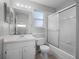 Well-lit bathroom featuring a vanity with a large mirror and a shower with glass doors at 156 Oak Grove Rd, Winter Park, FL 32789