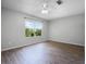 A bright bedroom with laminate wood flooring and a large window offering a pleasant outdoor view at 156 Oak Grove Rd, Winter Park, FL 32789