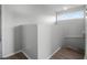 A well-lit hallway with smooth walls, leading up the carpeted stairs and wooden laminate on the landing at 156 Oak Grove Rd, Winter Park, FL 32789