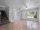 Open concept living room with large windows and tile floor at 156 Oak Grove Rd, Winter Park, FL 32789