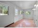 Enclosed sunroom with several windows and tile flooring at 156 Oak Grove Rd, Winter Park, FL 32789