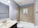 Full bathroom with tub and shower combination, neutral tile, and vanity with sink at 2690 Ne 42Nd Pl, Ocala, FL 34479