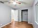 This bedroom features neutral walls, wood-look floors, closet space and ceiling fan at 2690 Ne 42Nd Pl, Ocala, FL 34479