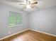 Clean bedroom with neutral walls, laminate floors, a ceiling fan and a bright window at 2690 Ne 42Nd Pl, Ocala, FL 34479