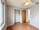 Neutral bedroom featuring laminate flooring, a door to hall and closet space with mirrored doors at 2690 Ne 42Nd Pl, Ocala, FL 34479