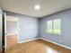Comfortable bedroom with a window showing the outdoors and hardwood floors at 2690 Ne 42Nd Pl, Ocala, FL 34479