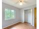 Comfortable bedroom with a ceiling fan, laminate flooring, window view and convenient closet space at 2690 Ne 42Nd Pl, Ocala, FL 34479