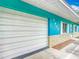 Turquoise house with white trim has an attached garage and stone-style accents underneath the windows at 2690 Ne 42Nd Pl, Ocala, FL 34479