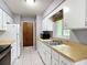 Functional kitchen with ample cabinet space, neutral counters, tile floors, and essential appliances at 2690 Ne 42Nd Pl, Ocala, FL 34479