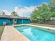 Beautiful backyard pool area, enhanced by a vibrant green lawn and clear blue skies at 2690 Ne 42Nd Pl, Ocala, FL 34479