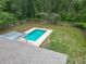The backyard features a beautiful pool with a patio and a lawn surrounded by trees at 2690 Ne 42Nd Pl, Ocala, FL 34479