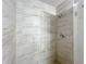 The shower features neutral tile, a new shower head and modern fixtures at 2690 Ne 42Nd Pl, Ocala, FL 34479