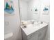 Bright bathroom featuring white vanity, contemporary décor, and modern fixtures at 4149 Paragraph Dr, Kissimmee, FL 34746