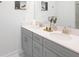 Bathroom with a double sink vanity, white quartz countertops, and modern fixtures at 4149 Paragraph Dr, Kissimmee, FL 34746