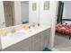 Dual sink vanity located in a bathroom featuring tile floors and contemporary fixtures at 4149 Paragraph Dr, Kissimmee, FL 34746