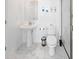 Bright white bathroom featuring tiled floors, pedestal sink, and standing shower at 4149 Paragraph Dr, Kissimmee, FL 34746