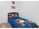 Bedroom with a bed featuring Marvel themed bedspread and artwork at 4149 Paragraph Dr, Kissimmee, FL 34746