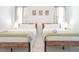 Comfortable bedroom featuring two beds with white linens and decorative artwork at 4149 Paragraph Dr, Kissimmee, FL 34746
