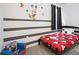 Adorable bedroom featuring gray striped walls and a Mickey Mouse theme at 4149 Paragraph Dr, Kissimmee, FL 34746