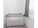Pack and play beside a window in a neutral-toned room, providing a cozy and safe space for infants at 4149 Paragraph Dr, Kissimmee, FL 34746