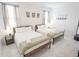 Bright bedroom showcasing two beds with plush linens and stylish decor at 4149 Paragraph Dr, Kissimmee, FL 34746