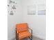 Bright room featuring an orange modern chair and seaside themed artwork on the walls at 4149 Paragraph Dr, Kissimmee, FL 34746