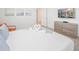 Bright bedroom featuring a heart-shaped towel arrangement on a neatly made bed with a flat screen TV at 4149 Paragraph Dr, Kissimmee, FL 34746