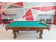 Spacious game room featuring a pool table and contemporary geometric patterned walls at 4149 Paragraph Dr, Kissimmee, FL 34746