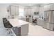 Modern kitchen featuring stainless steel appliances, ample cabinet space, and a large center island with seating at 4149 Paragraph Dr, Kissimmee, FL 34746