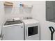Efficient laundry room with modern washer and dryer, along with ample shelving for storage at 4149 Paragraph Dr, Kissimmee, FL 34746