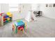 Bright playroom featuring a table, chairs, toy storage, teepee, and desk in a neutral color scheme at 4149 Paragraph Dr, Kissimmee, FL 34746