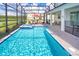 Backyard pool area with a screened-in enclosure overlooking a beautiful water view at 4149 Paragraph Dr, Kissimmee, FL 34746
