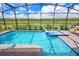 Enjoy this screened-in pool and spa with a scenic water view in a private backyard oasis at 4149 Paragraph Dr, Kissimmee, FL 34746
