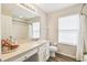 Well-lit bathroom featuring a white vanity, modern fixtures, and a shower-tub combination at 440 Langham Dr, Davenport, FL 33897