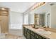 Elegant bathroom with a corner tub, double sinks, and vanity at 440 Langham Dr, Davenport, FL 33897