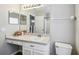 Well-lit bathroom featuring a white vanity, modern fixtures, and a toilet at 440 Langham Dr, Davenport, FL 33897